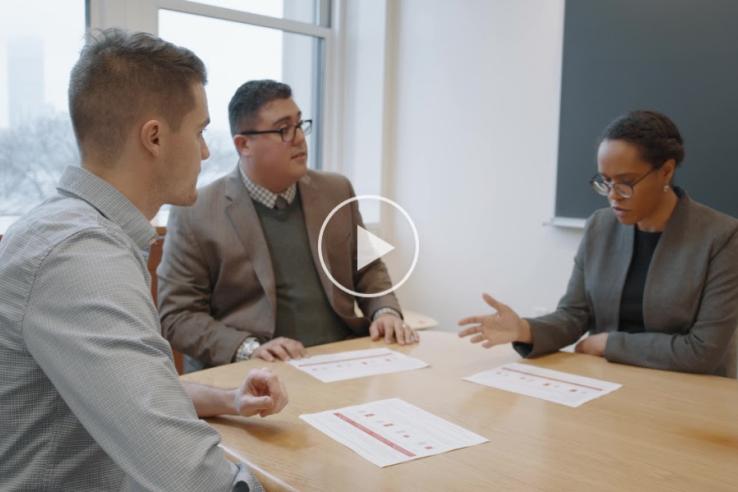 The thumbnail of J-PAL North America's evaluation incubators video shows three people in business attire meeting around a table.