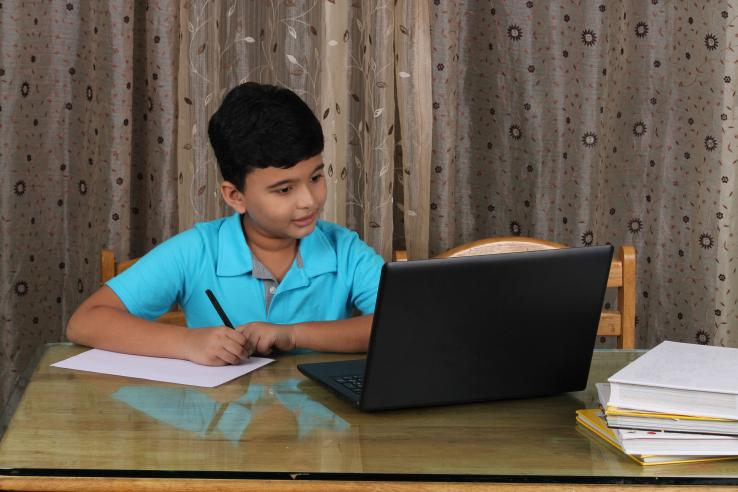 Young boy learning through laptop
