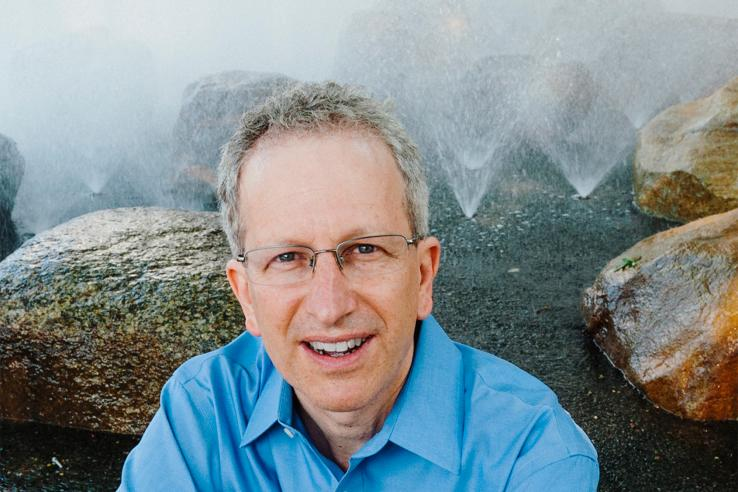 Photo of Larry Katz with a background of rocks