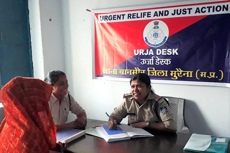 Officer signing papers at URJA desk