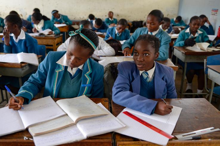 Two girls doing schoolwork at desk