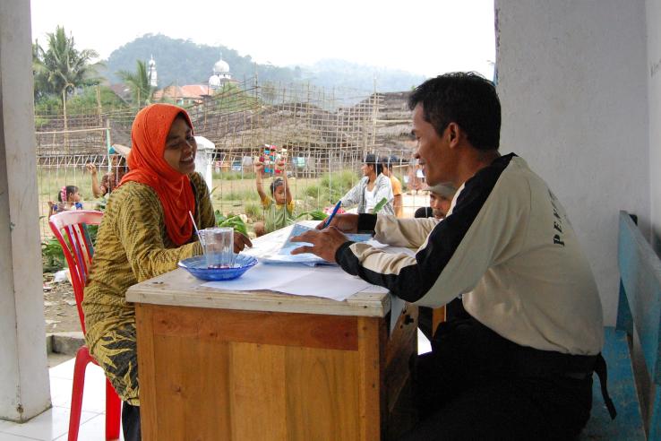 Two people discussing anti-poverty program