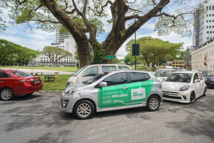 Car with Grab advertisement.