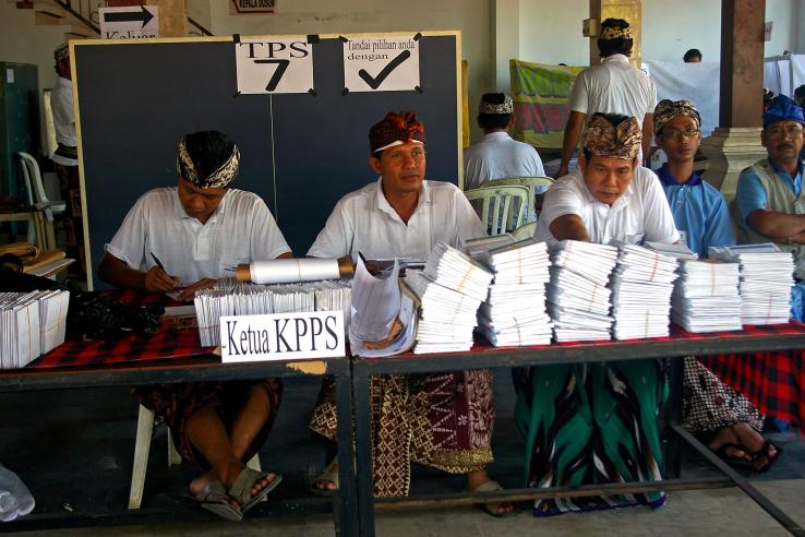 Election officials with ballot papers in a polling station, Denpasar, Bali 