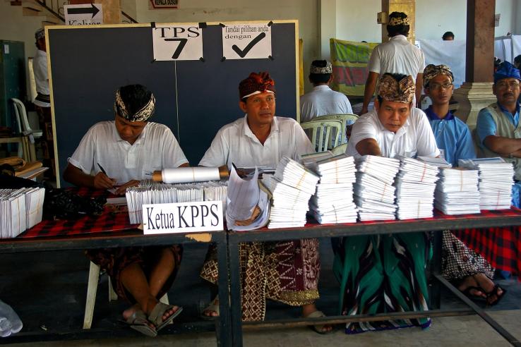 Election officials with ballot papers in a polling station, Denpasar, Bali