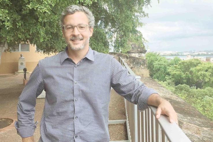 Gustavo Bobonis in front of fence and trees