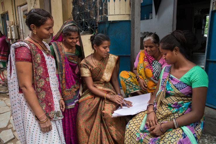 Women gather to discuss work outside their homes in Gujarat, India.
