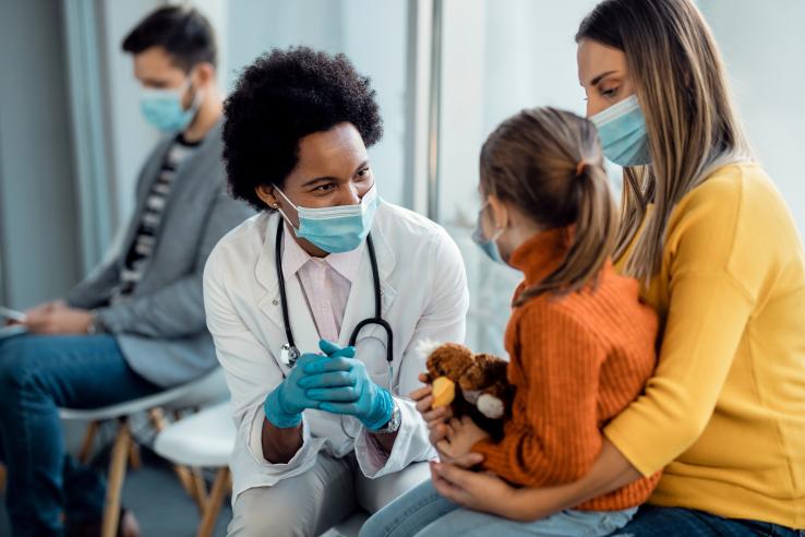 Doctor speaking to parent and child