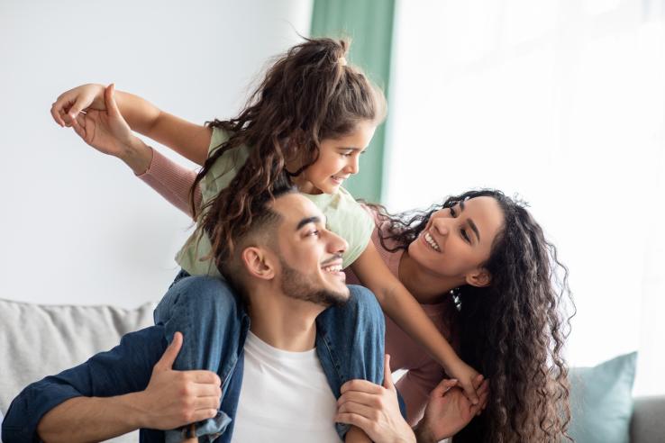 Family of three happily playing together