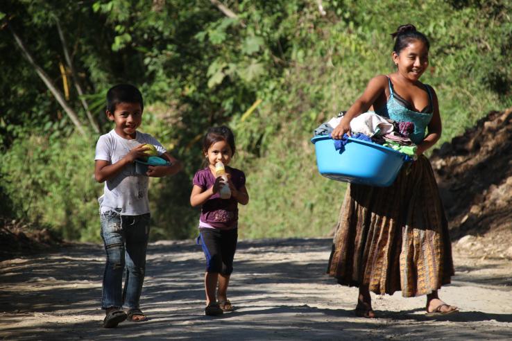 Young woman and two kids walking 