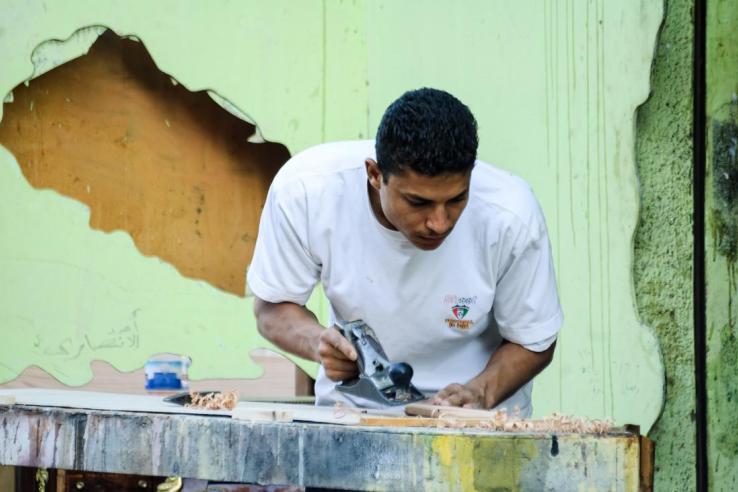 A man using a saw