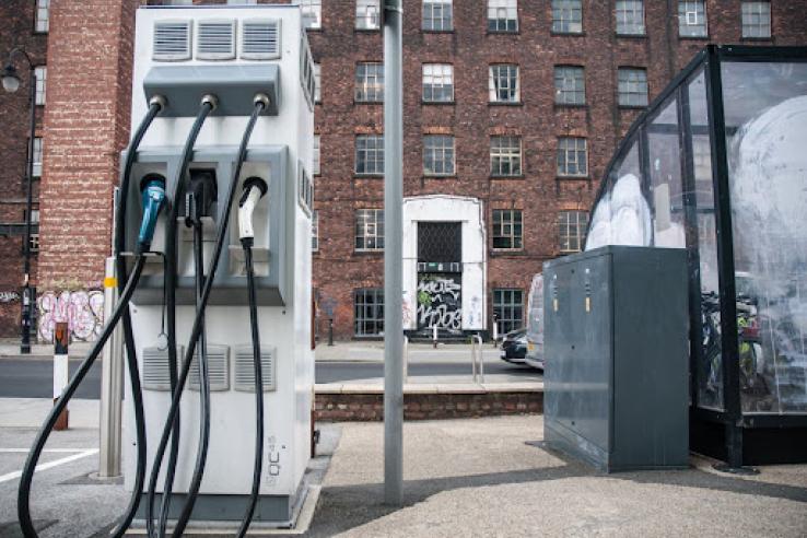 Electric car charging point with urban backdrop