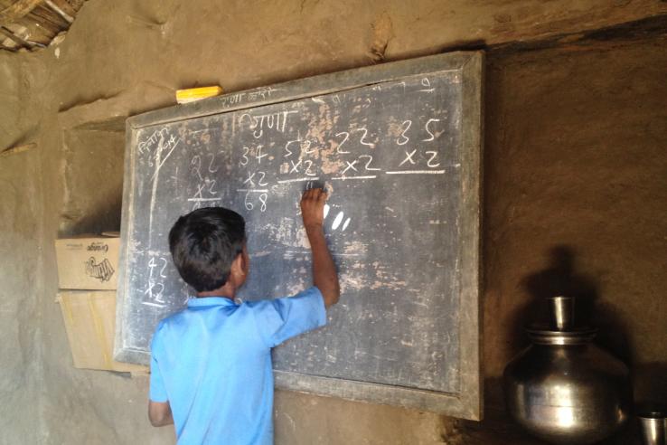 A student at a school solving math problems in Udaipur, India
