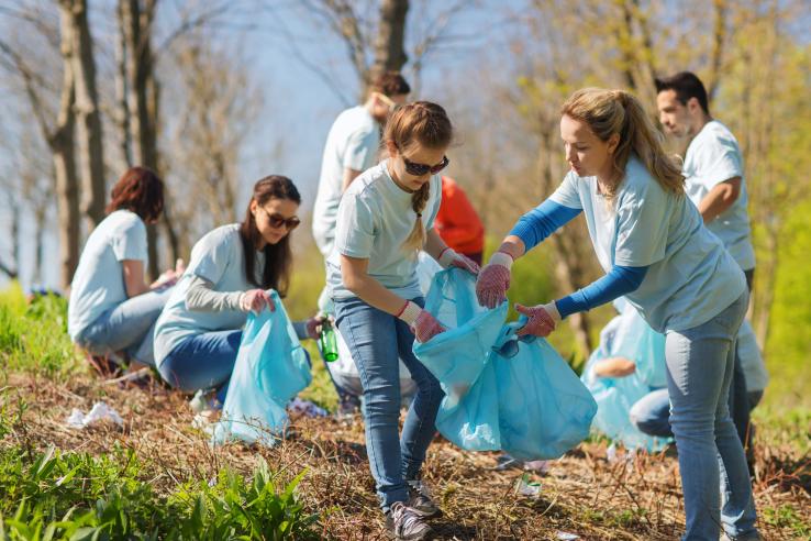Summer youth employment participants cleaning up a local field 