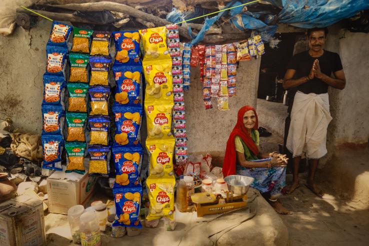 A woman sitting next to a standing man in her shop