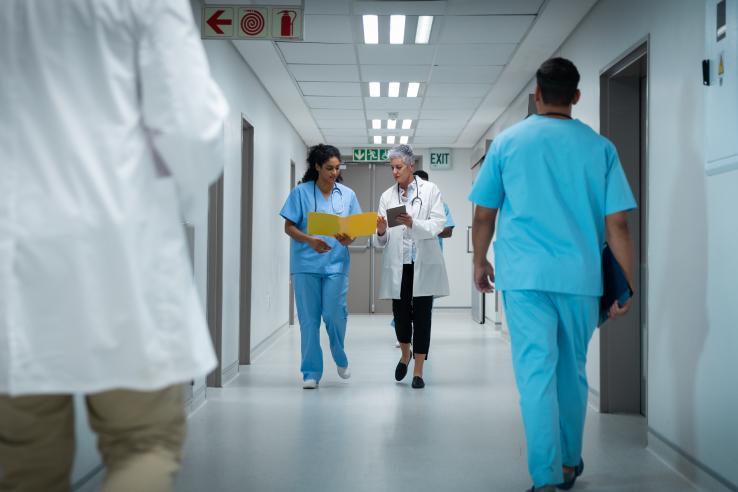 Doctor and nurse walking down hospital hallway