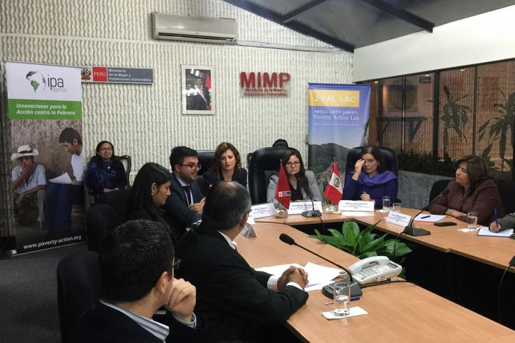 People sit around a conference table.