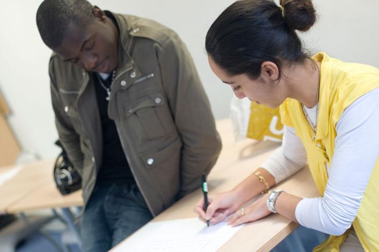 Job seekers work on their applications