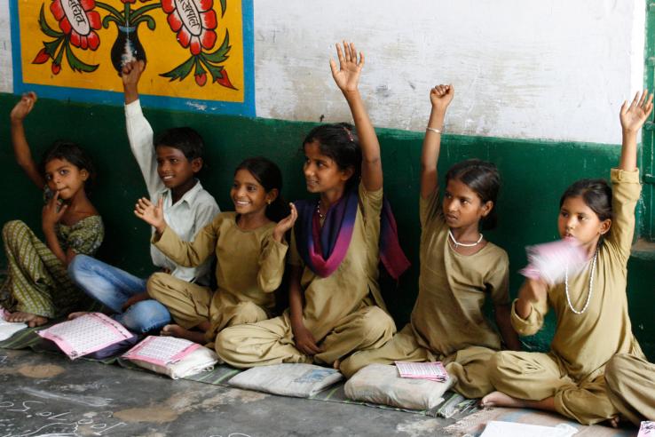 Indian schoolchildren raise their hands