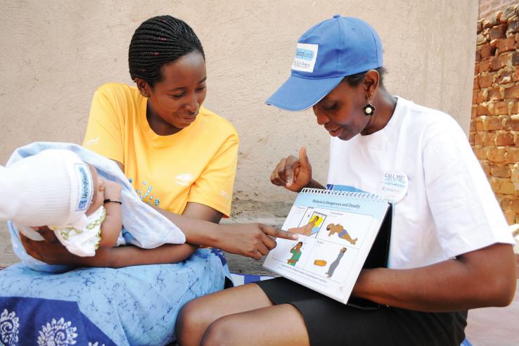 A healthcare worker and mother with a baby in sub-Saharan Africa.