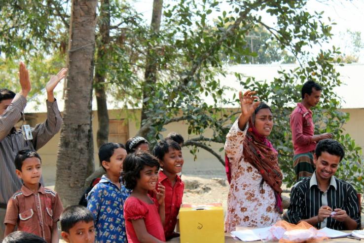 Man and woman lead demonstration as children look on