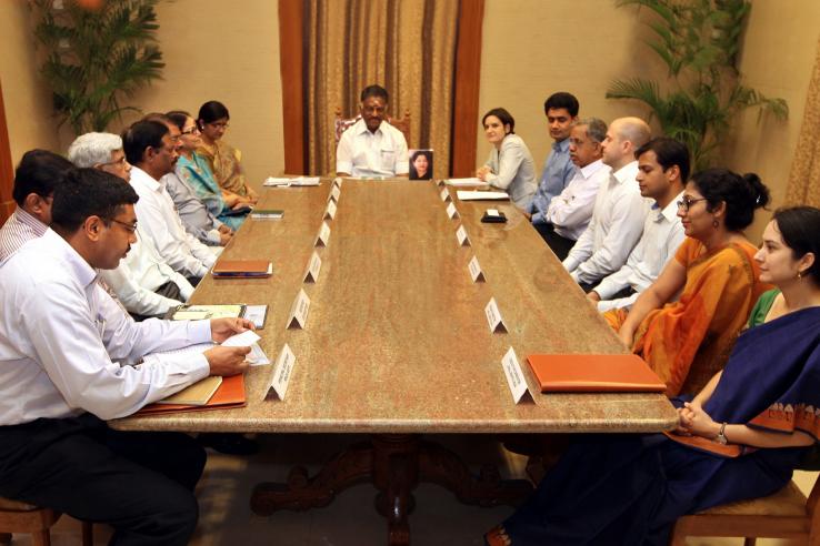 Government officials and J-PAL staff sit at meeting table