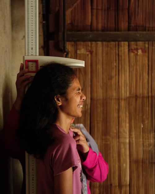 A girl having her height measured