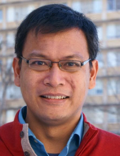 headshot of Arya Gaduh wearing a red shirt