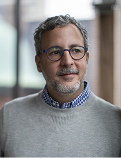 Headshot of Gustavo Bobonis in grey sweater