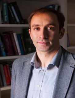 Headshot of Andrew Zeitlin wearing gray shirt