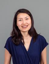 A headshot of a woman wearing a blue shirt.