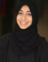 A headshot of a woman wearing black