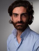 headshot of Paolo Falco wearing a blue shirt