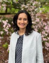 Headshot of Ina Ganguli in a gray blazer