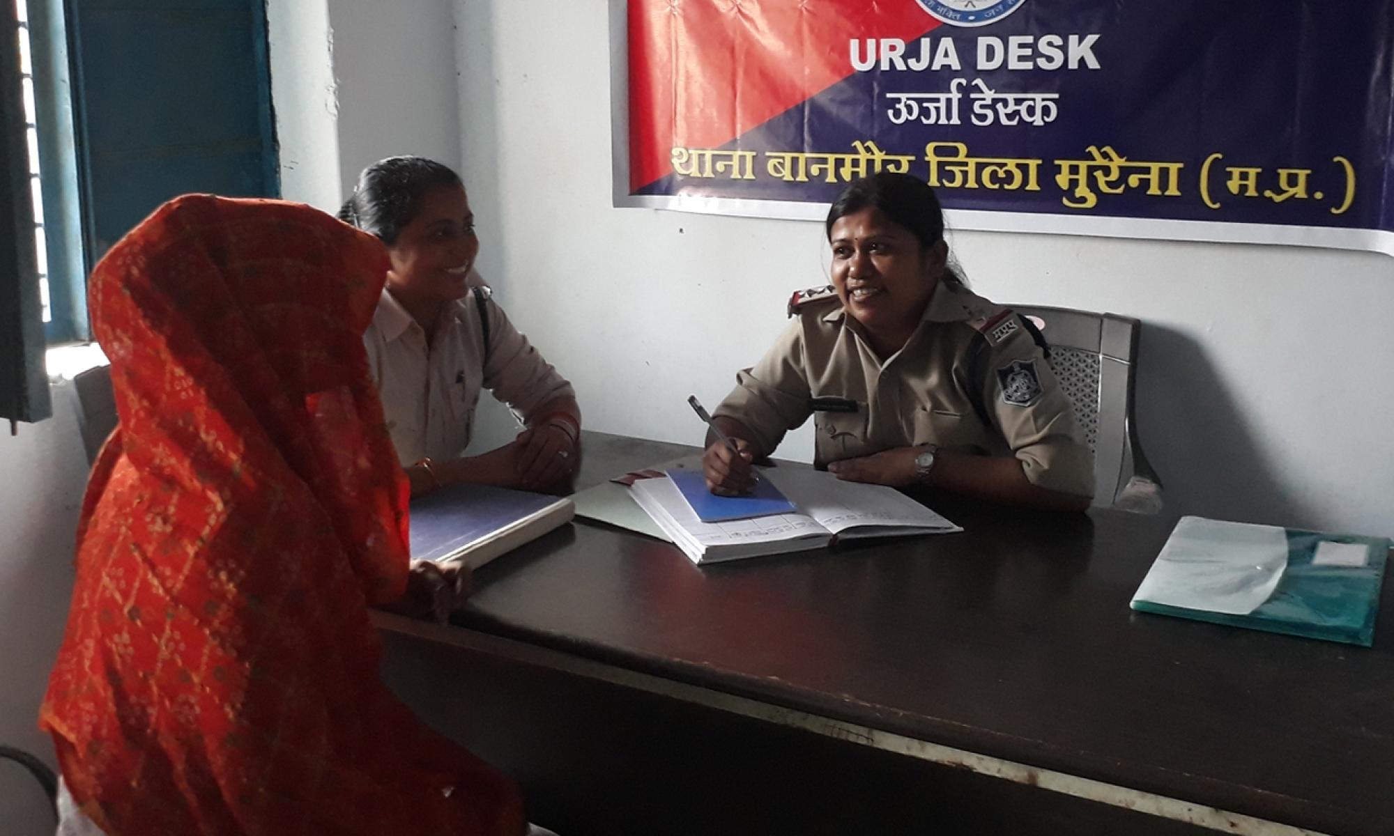 A woman speaks to a female officer
