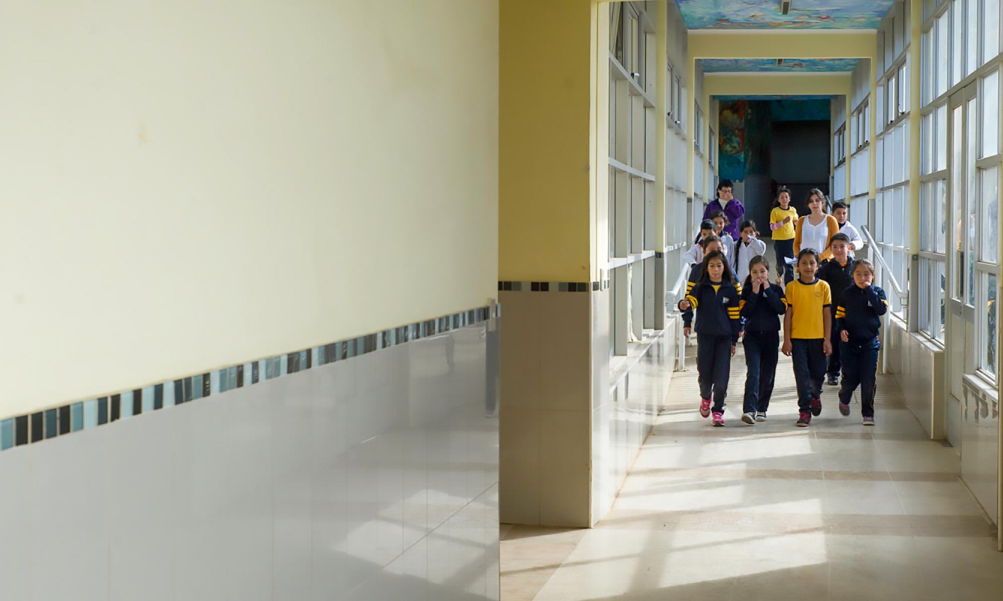 Group of students walking down a long hallway