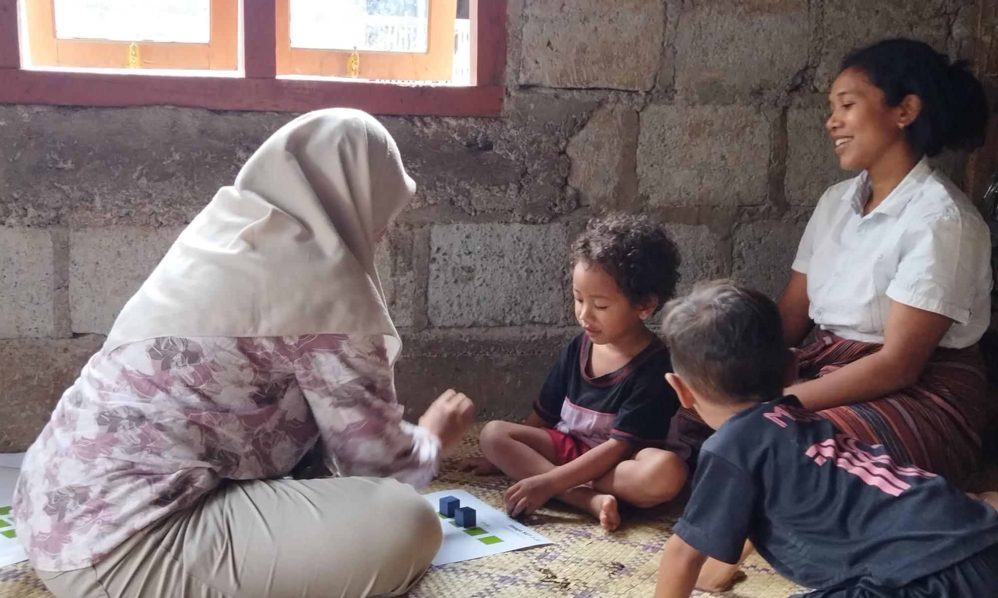 Accessor working through an assessment with two children and a caregiver 