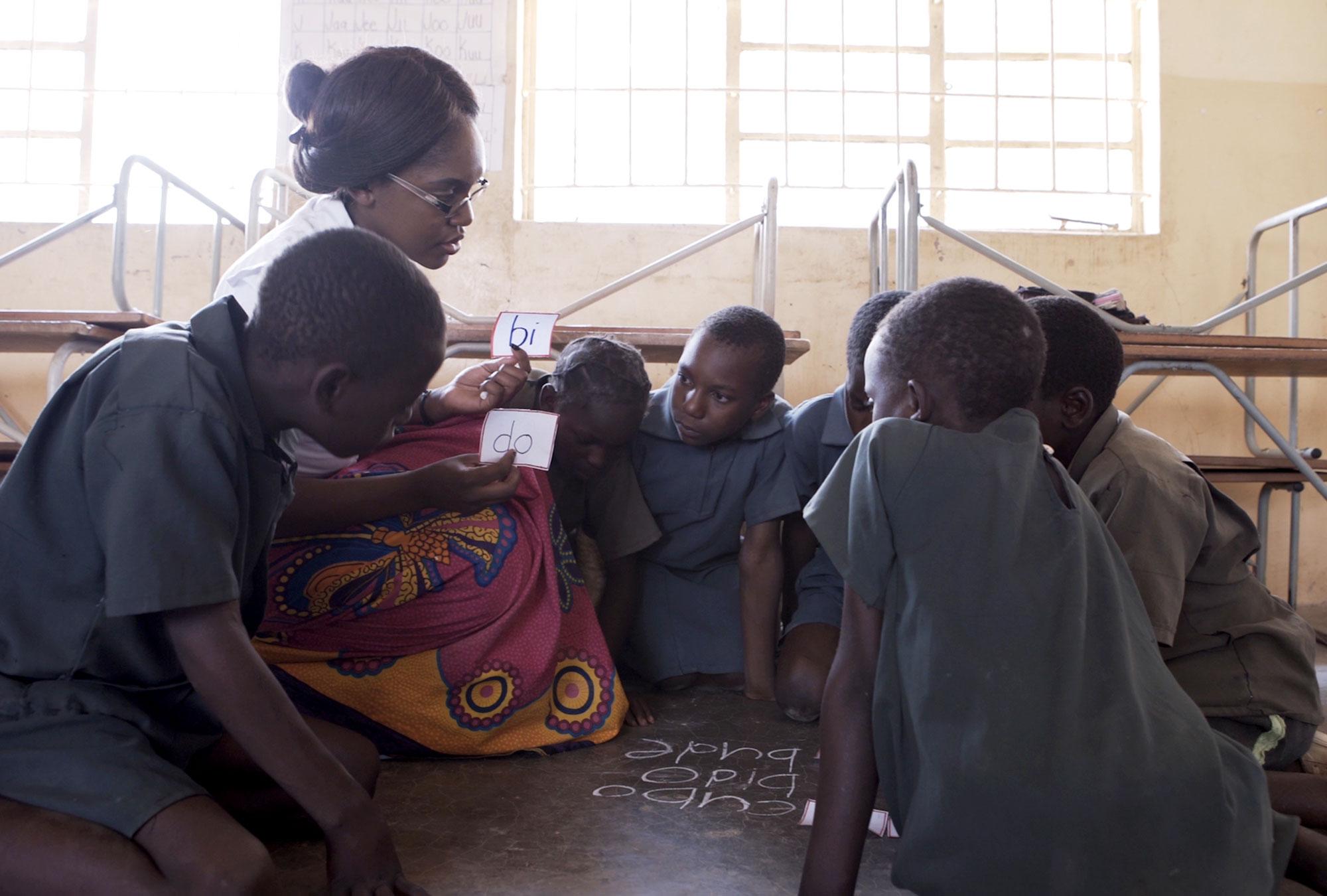 Woman teaching students in Africa