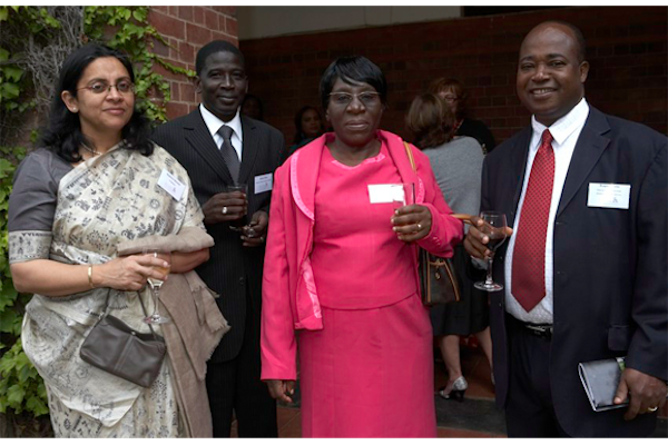 Three people pose for a photo at J-PAL Africa's launch event.