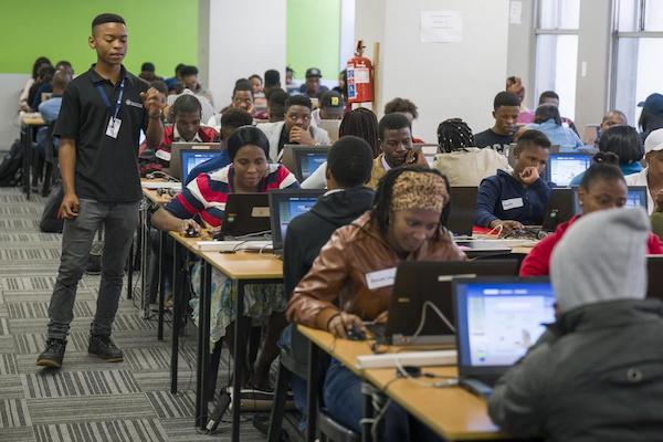 Children learning on laptops in a classroom