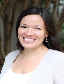  Elizabeth Linos in a white shirt and light grey jacket