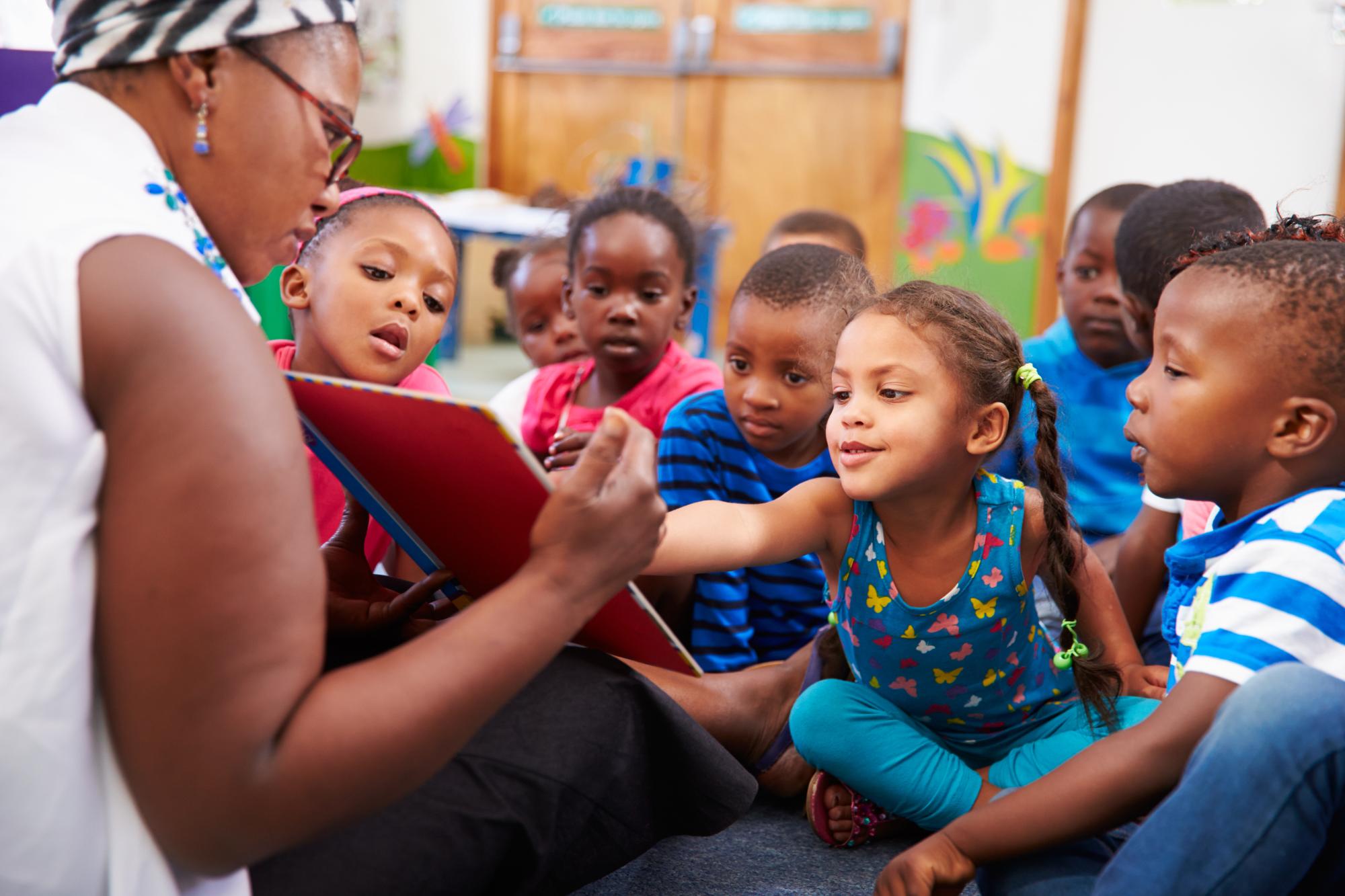 Teacher with children in a classroom.