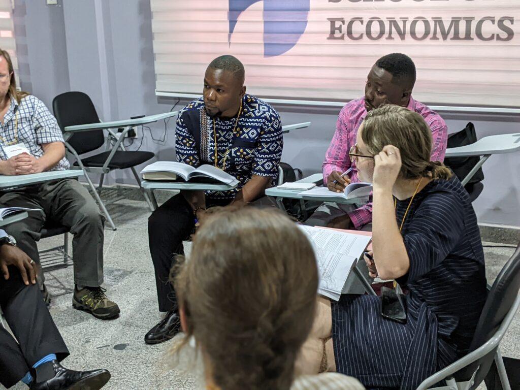 Students sitting as desks at J-PAL Africa’s 2022 Evaluating Social Programs course at the African School fof Economics in Abuja, Nigeria