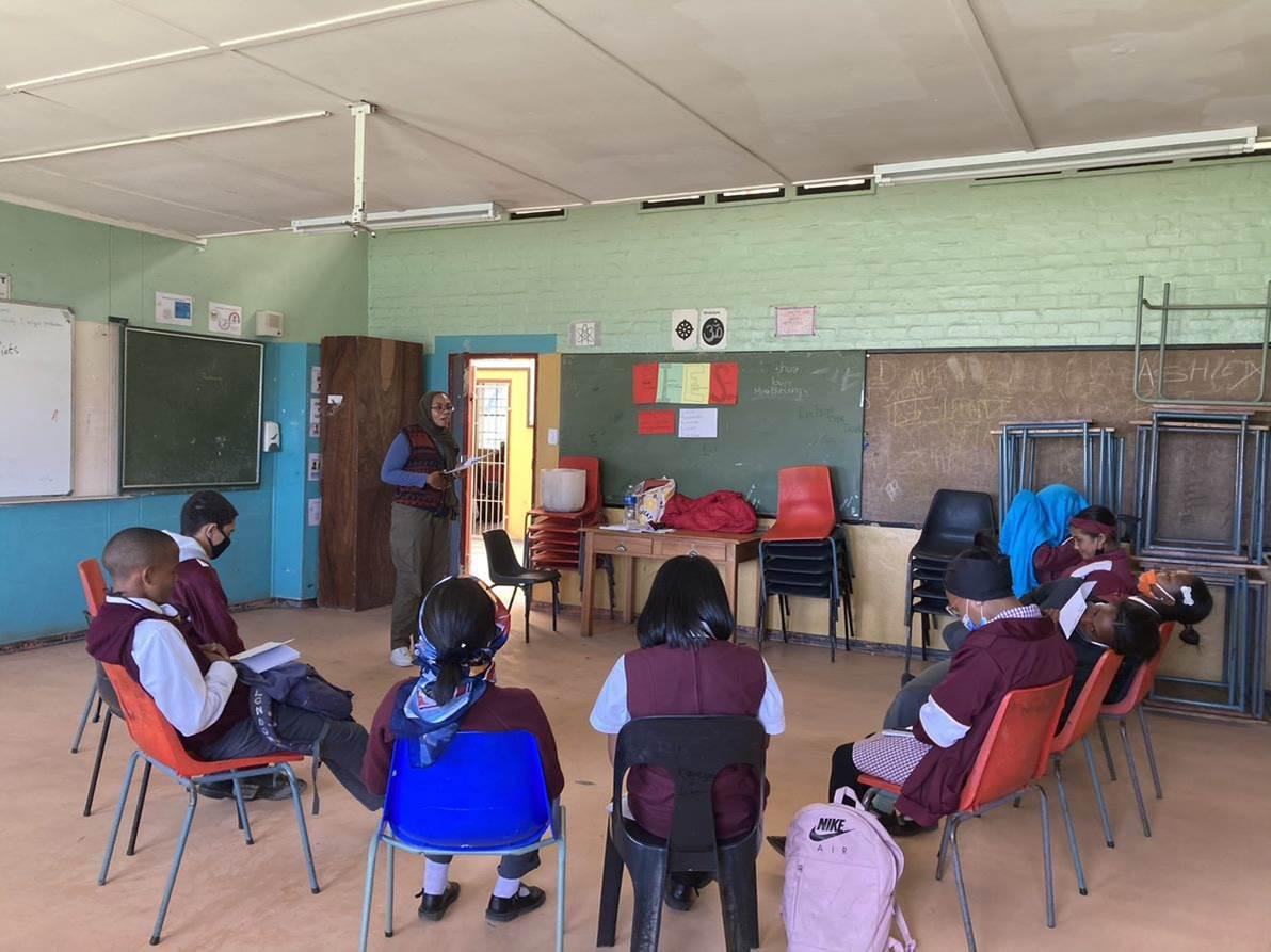 Children sit in circle in classroom