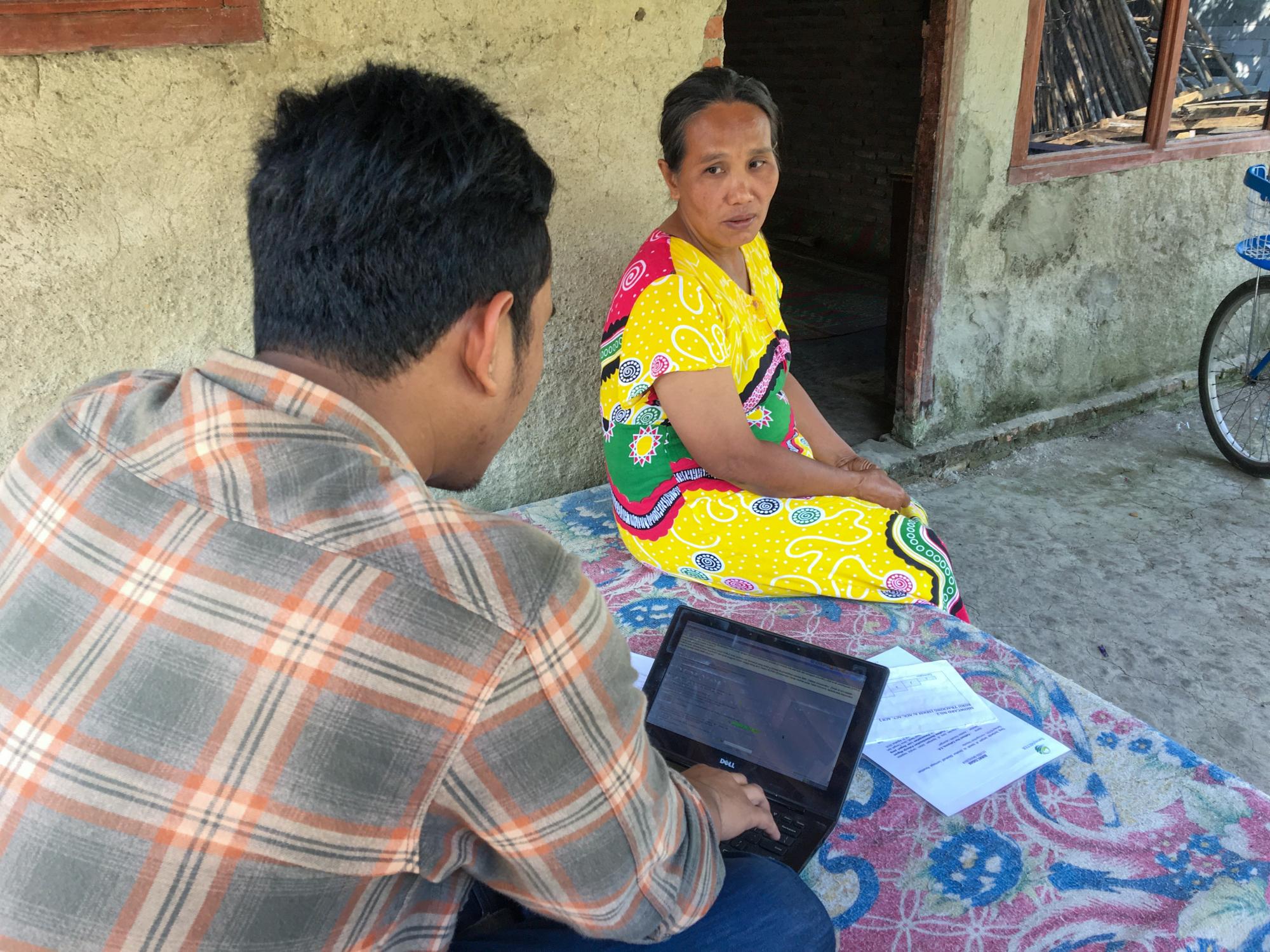 Zeqi Yasin interviewing a respondent for an evaluation in Indonesia. 