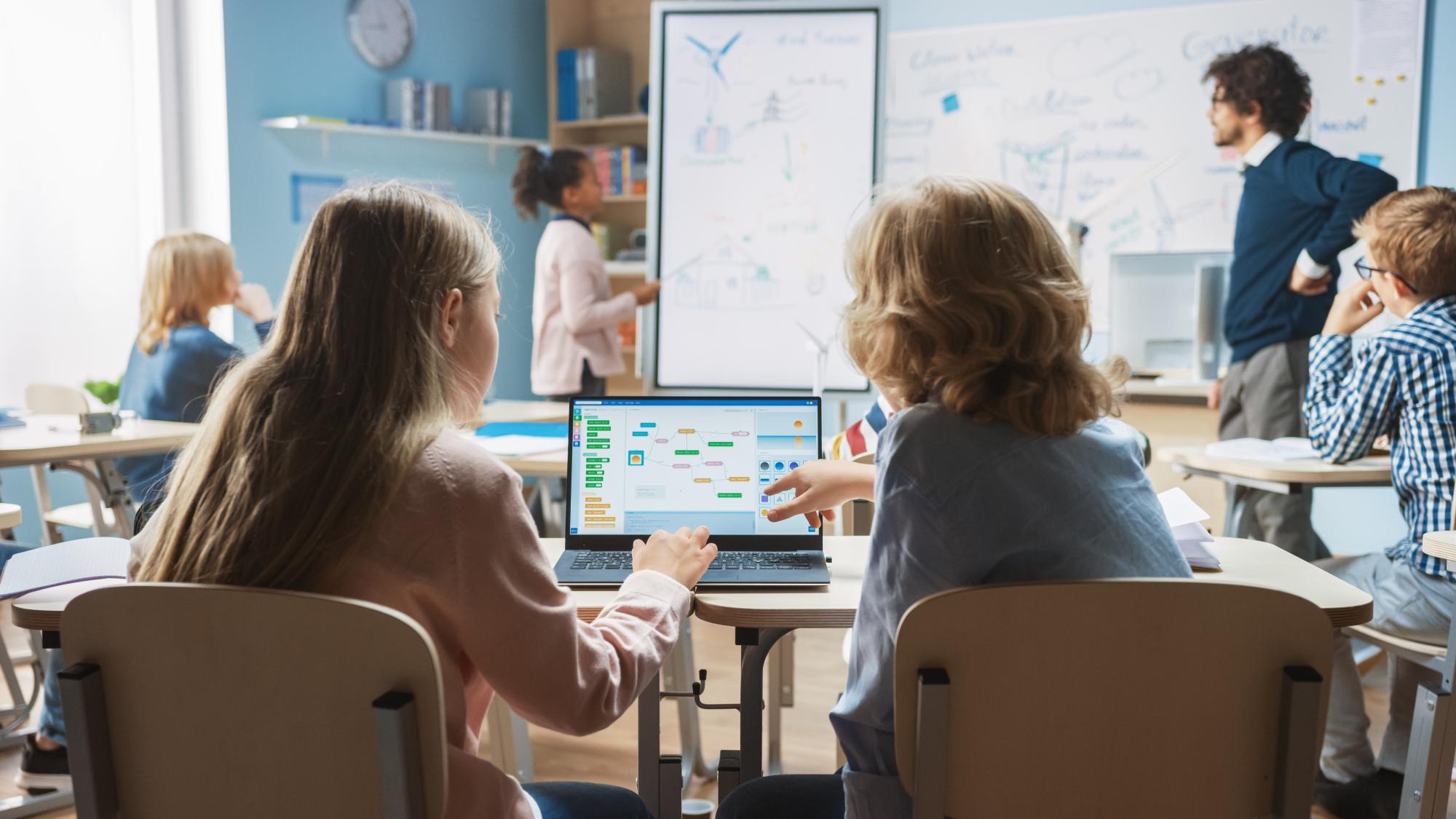 Two students look at a computer screen