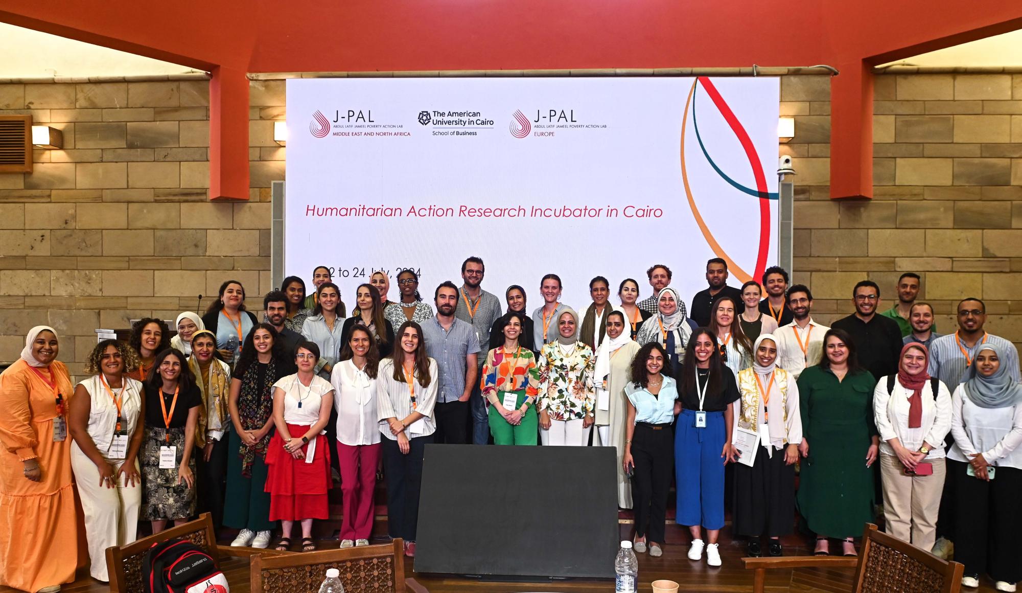 A large group of people stand on a stage