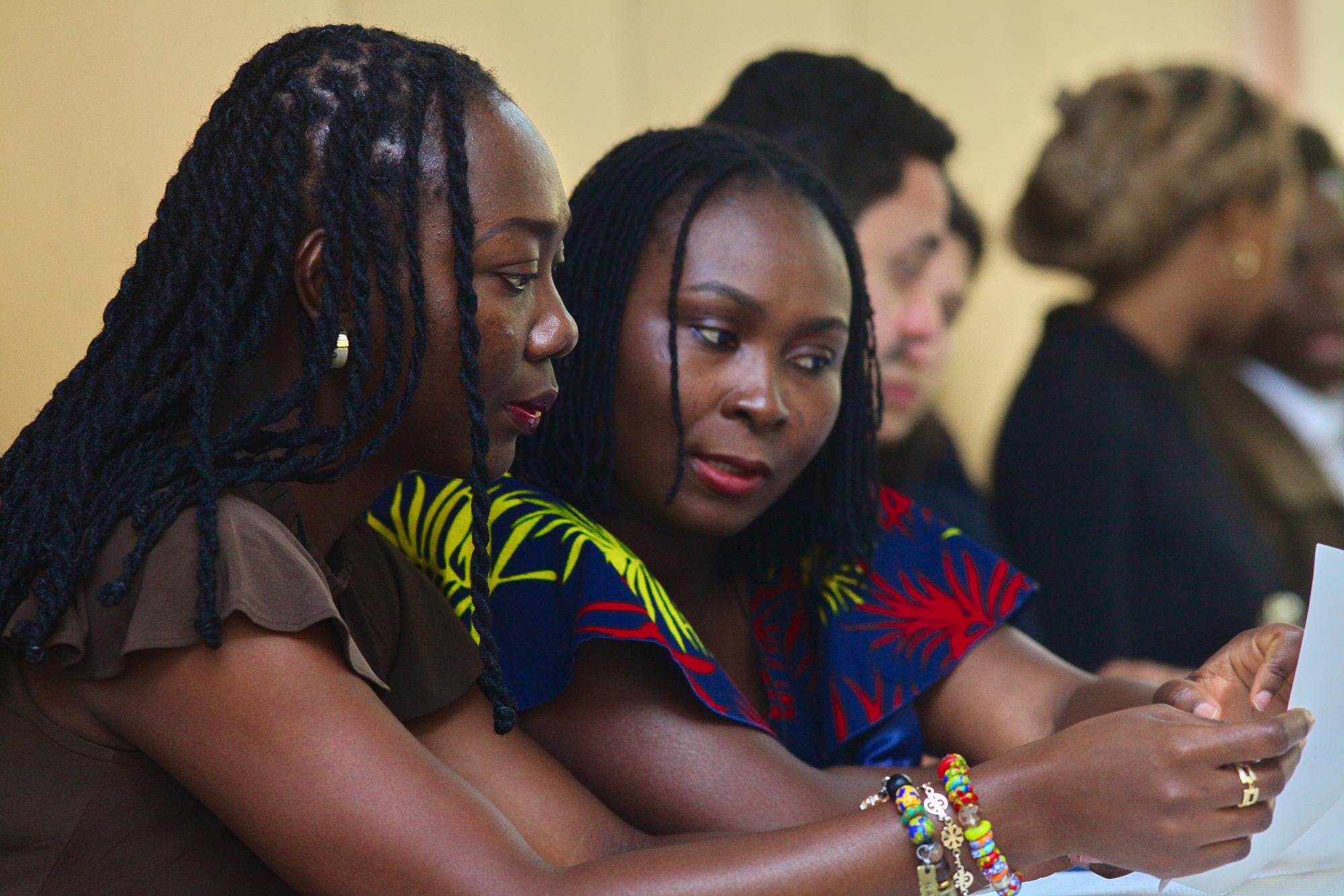 Two women reviewing a document closely