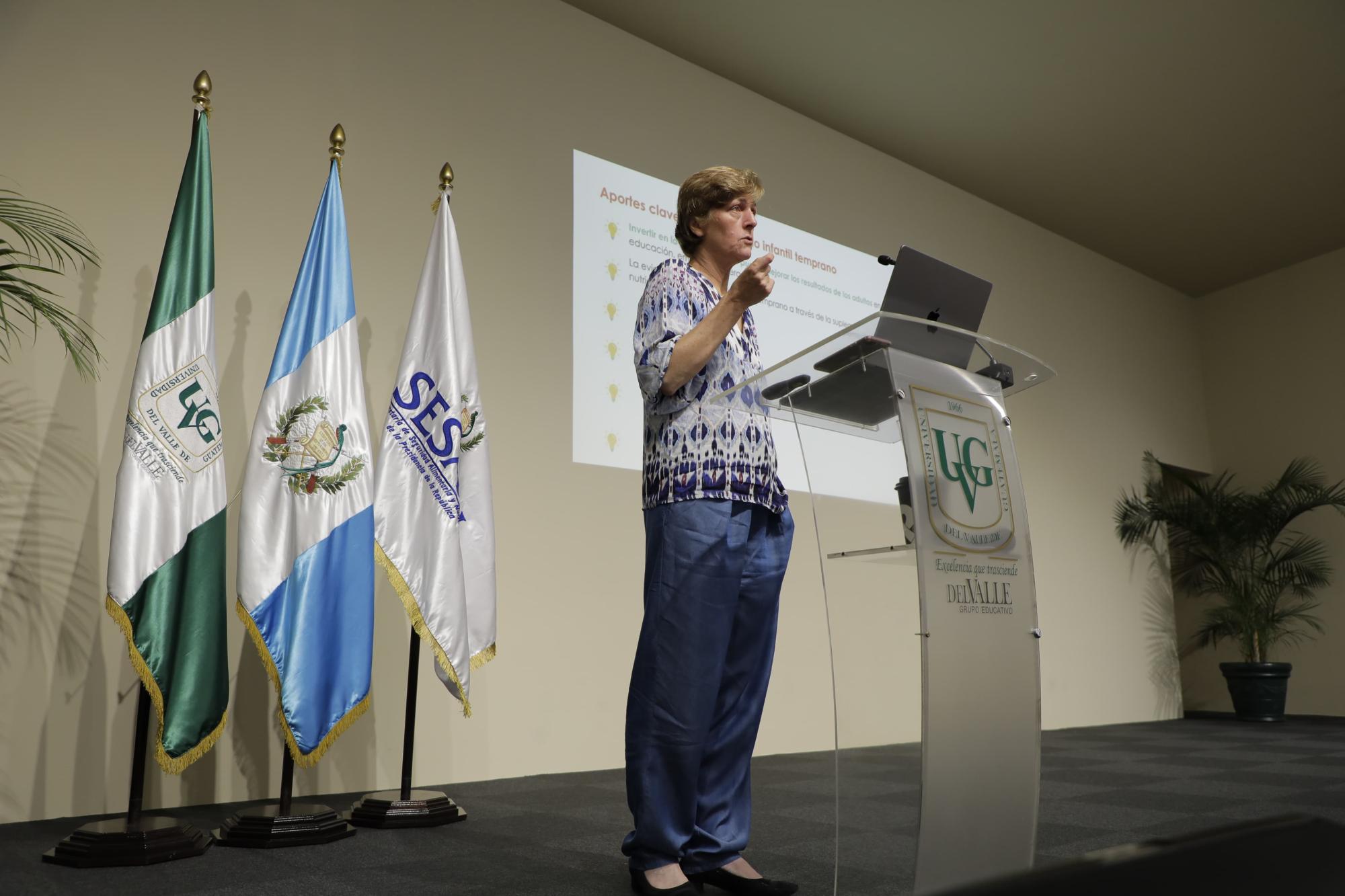 Karen Macours speaking on a stage
