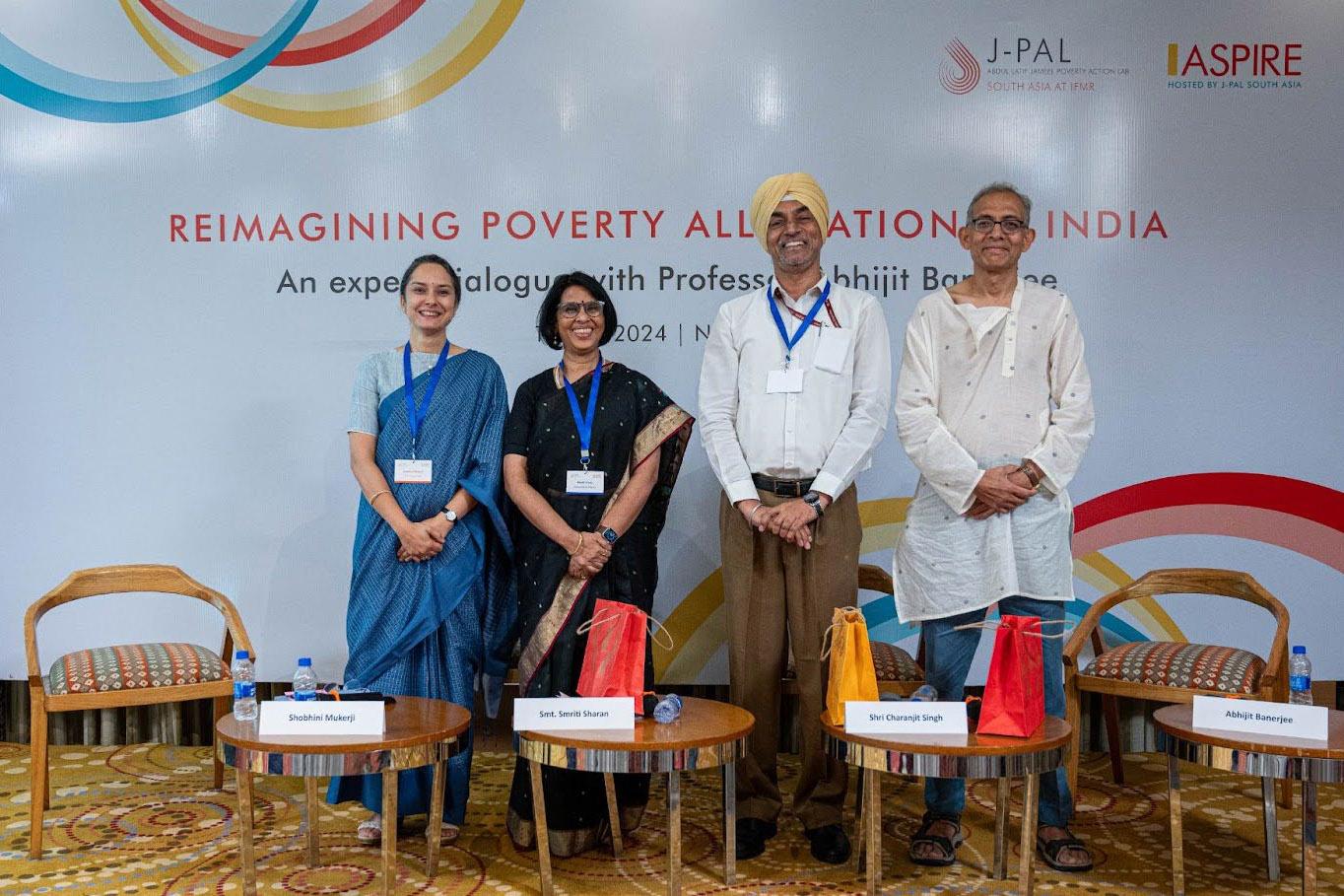 Two women and two men stand smiling